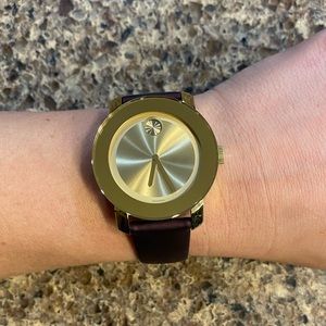 Movado Bold metallic purple rather band and gold face.